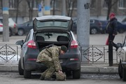 A member of the Ukrainian military takes items from the back of a car in Sievierodonetsk, the Luhansk region, eastern Ukraine, Thursday, Feb. 24, 2022. Russian President Vladimir Putin on Thursday announced a military operation in Ukraine and warned other countries that any attempt to interfere with the Russian action would lead to "consequences you have never seen." (AP Photo/Vadim Ghirda)