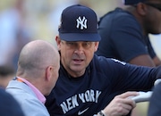 New York Yankees manager Aaron Boone, right, talks with general manager Brian Cashman during batting practice before Game 1 of the baseball World Series, Friday, Oct. 25, 2024, in Los Angeles. (AP Photo/Julio Cortez)