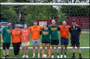 Todd Hack's family, Ken Granowski (far left, Director of Operations at Silver Lake Soccer Academy) and Chris Vega (far right, President of Silver Lake Soccer Academy) pose together during The Todd Hack Memorial Game on June 6, 2025.