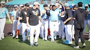 Pablo Sandoval is greeted by teammates at first base after hitting a walk off single.