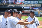 Bernie Williams watches as Johnny Damon, Mariano Rivera and Reggie Jackson take a selfie before the Yankees' Old-Timers Day game in 2019.