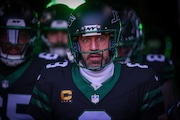 New York Jets quarterback Aaron Rodgers (8, center) emerges from the tunnel for pregame warmups as the Jets prepare to play the Seattle Seahawks, Sunday, Dec. 1, 2024, in East Rutherford, N.J.