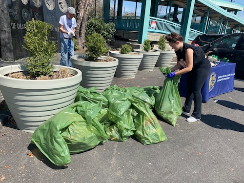 Dozens gather to clean veteran memorial, school and church streets for Earth Day