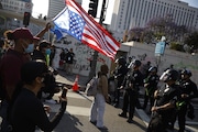 Los Angeles Police Department officers confront demonstrators during a protest in response to a series of United States Immigration and Customs Enforcement (ICE) raids, in Los Angeles, on Monday, June 9, 2025. (Stephen Lam/San Francisco Chronicle via AP)