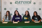 Notre Dame Academy seniors Anna Tutrone, Jordan Moore, Lizzie Coyne and Julia Donello, left to right, took part in a signing ceremony at the Grymes Hill school just days before they are to graduate.